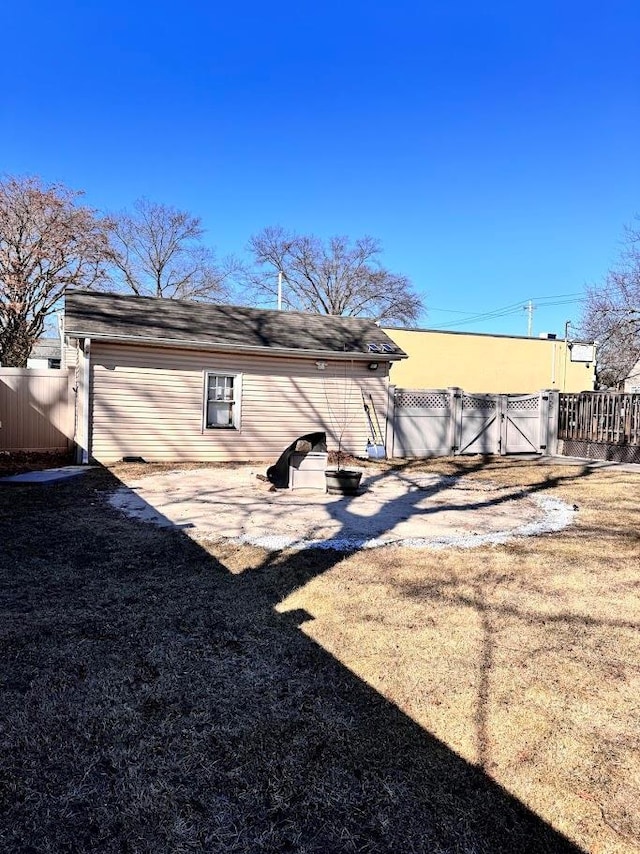 rear view of property with a gate and fence