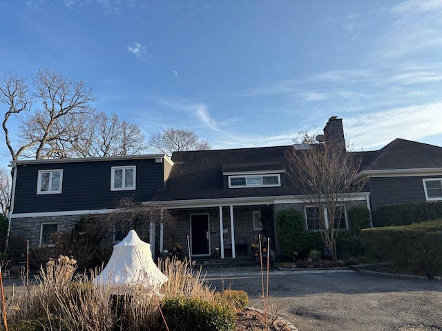 view of front facade with a porch and stone siding