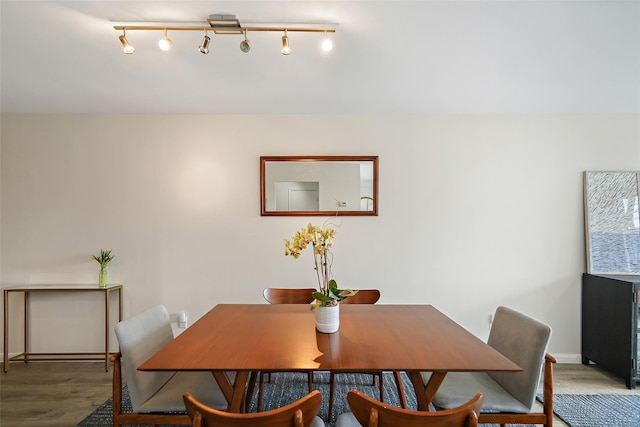 dining room featuring baseboards and wood finished floors