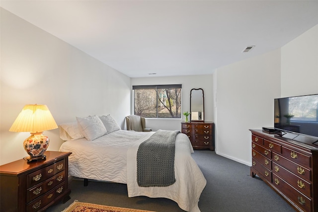 carpeted bedroom with visible vents and baseboards