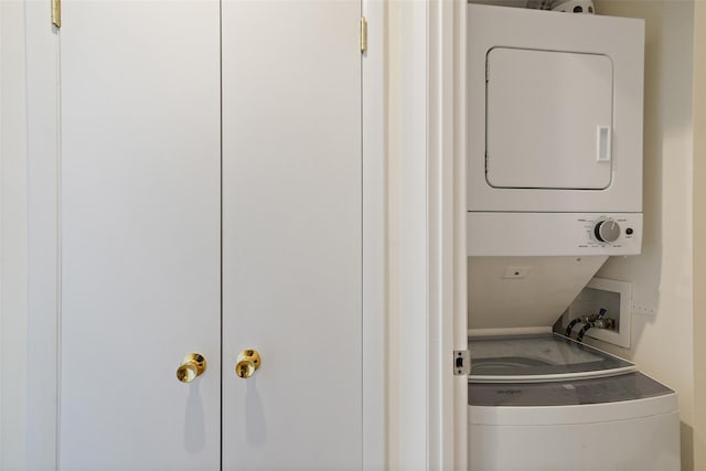 laundry area with stacked washer and dryer and laundry area