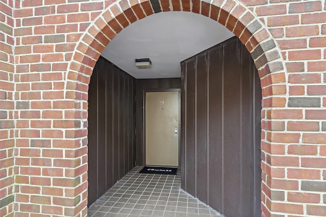 property entrance featuring brick siding