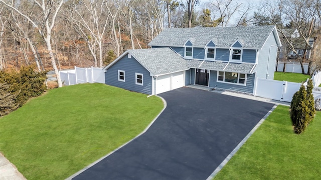 traditional-style home with a front yard, a gate, driveway, and fence private yard