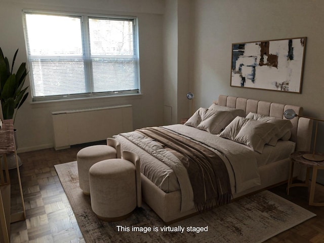 bedroom with radiator heating unit and baseboards