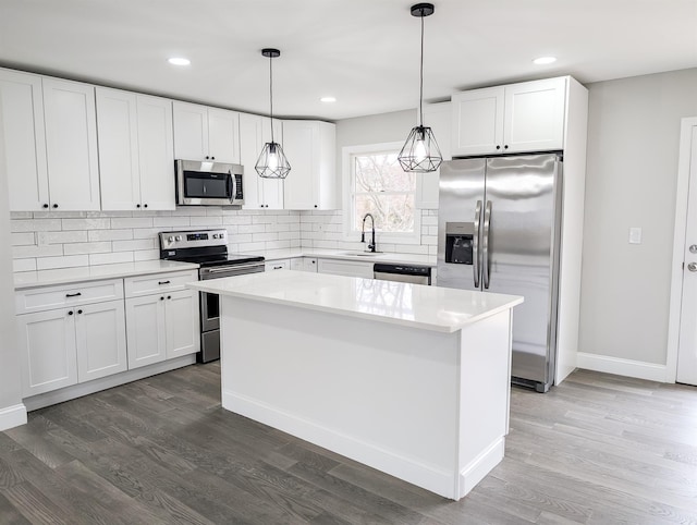 kitchen featuring appliances with stainless steel finishes, backsplash, and dark wood-type flooring