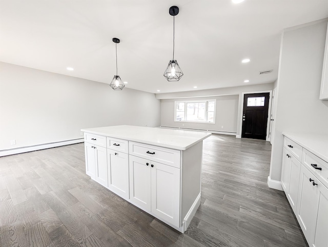 kitchen with a baseboard heating unit, light countertops, and wood finished floors