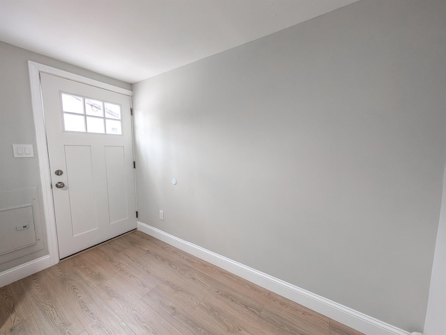 foyer featuring light wood finished floors and baseboards