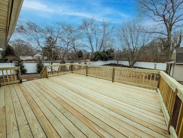 deck featuring a water view and a fenced backyard