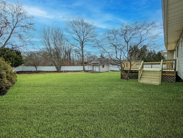 view of yard with a deck and fence