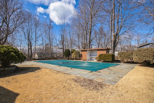 view of swimming pool with a fenced in pool, a patio, and an outdoor structure