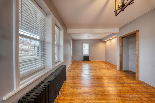 interior space featuring radiator and light wood finished floors