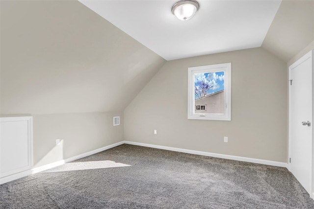 additional living space with lofted ceiling, carpet floors, visible vents, and baseboards