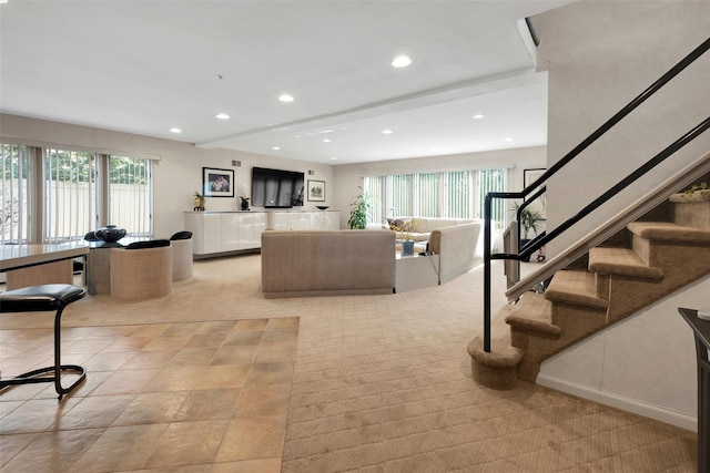 living room with stairway and recessed lighting