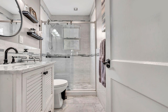 full bathroom with toilet, marble finish floor, tile walls, and a stall shower