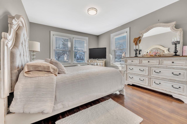 bedroom with dark wood-style flooring