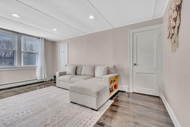 living area featuring baseboards, a baseboard heating unit, wood finished floors, and recessed lighting