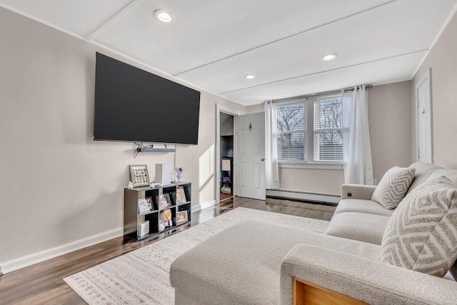 living area featuring baseboards, a baseboard heating unit, wood finished floors, and recessed lighting