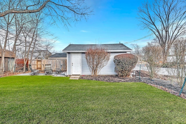 exterior space featuring a yard, an outdoor structure, and a fenced backyard