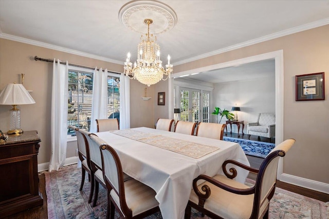 dining room with wood finished floors, baseboards, an inviting chandelier, french doors, and crown molding