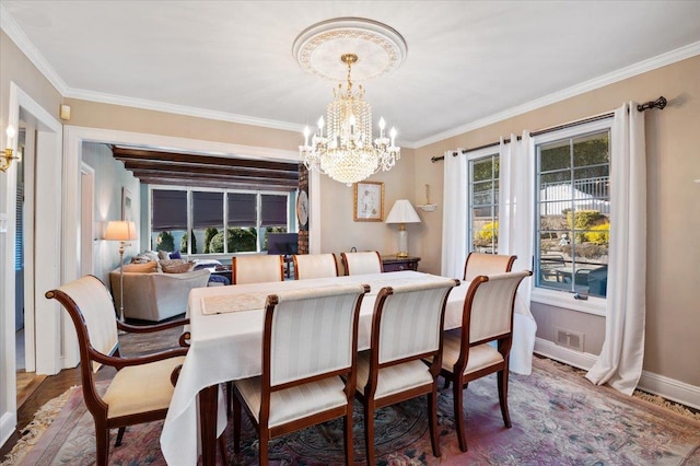 dining area with visible vents, baseboards, and ornamental molding