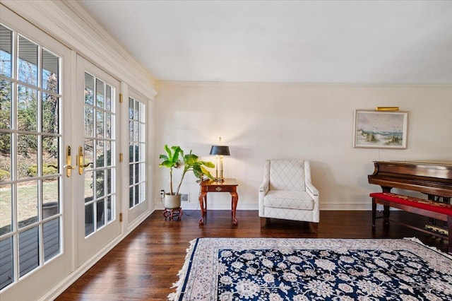 living area with plenty of natural light, french doors, baseboards, and wood finished floors