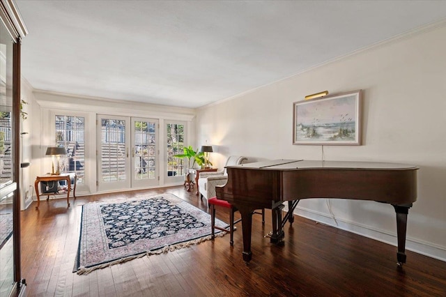 living area featuring french doors, crown molding, baseboards, and hardwood / wood-style floors