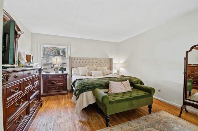 bedroom with light wood-style flooring and baseboards