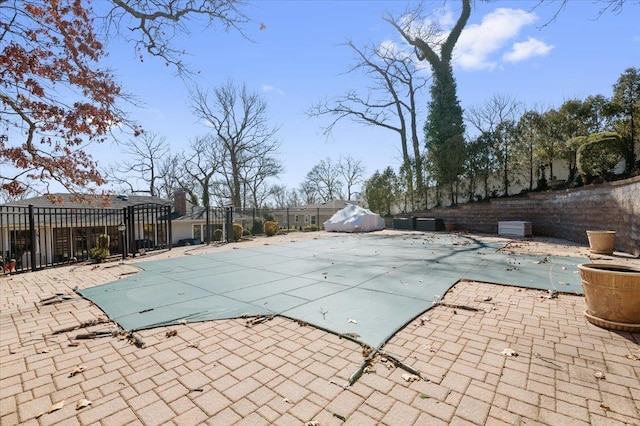 view of swimming pool featuring a patio area, fence, and a fenced in pool