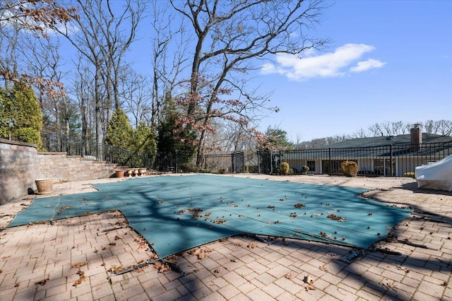 view of pool featuring a patio, fence, and a fenced in pool