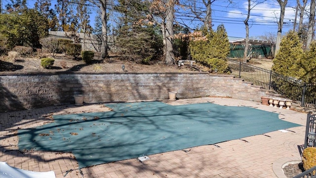 view of pool with a patio and fence