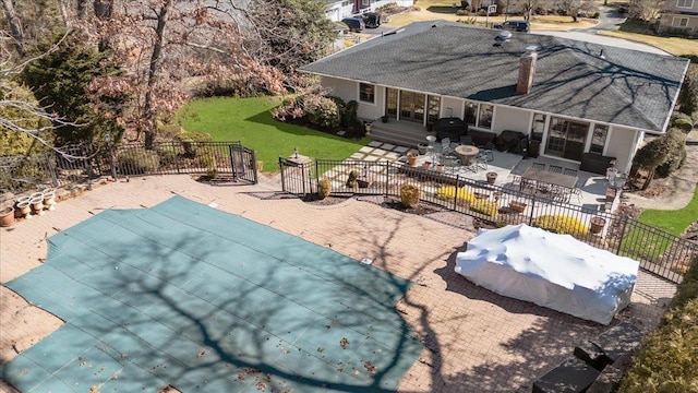 exterior space with grilling area, fence, a yard, and a patio area