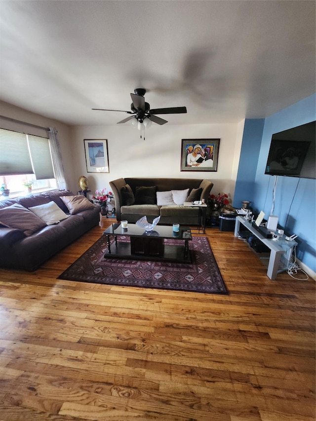 living room with ceiling fan and wood finished floors