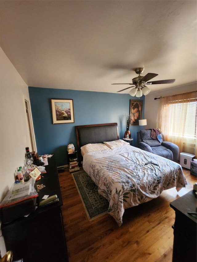 bedroom featuring a ceiling fan and wood finished floors