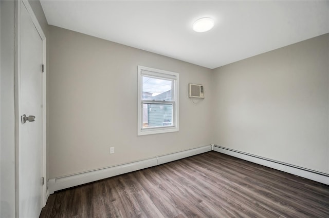 spare room featuring a wall unit AC and wood finished floors