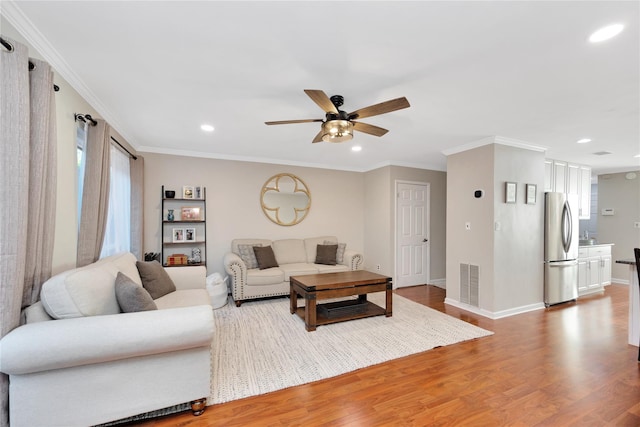 living room featuring recessed lighting, visible vents, crown molding, and wood finished floors