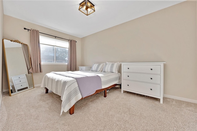 bedroom featuring carpet flooring and baseboards