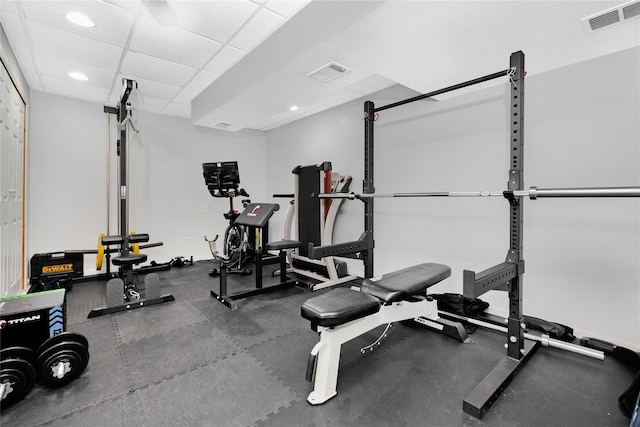 workout area featuring a paneled ceiling, visible vents, and recessed lighting