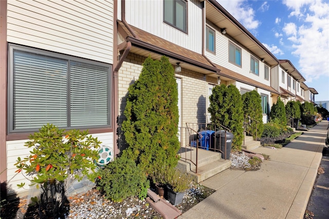 exterior space featuring brick siding