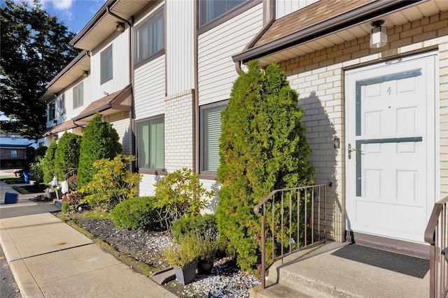 view of exterior entry with brick siding