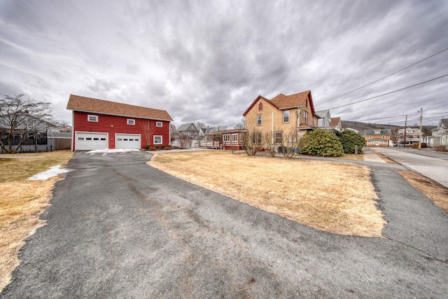 view of property exterior with a garage and a lawn