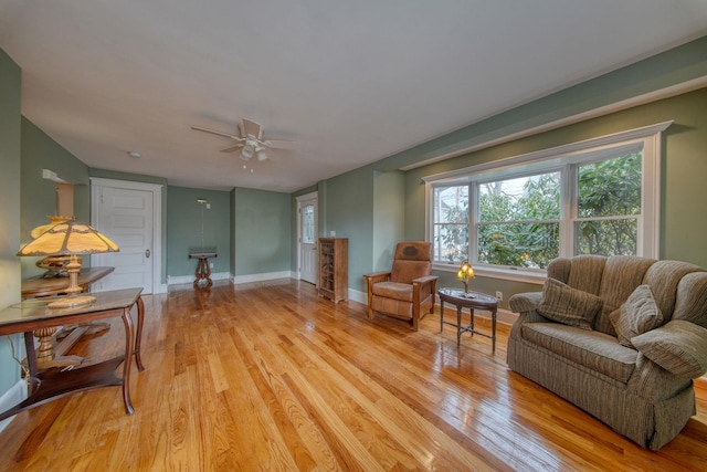 sitting room featuring light wood-style floors, ceiling fan, and baseboards