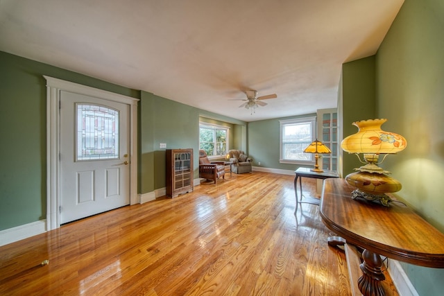 entrance foyer featuring light wood-style floors, baseboards, and a ceiling fan