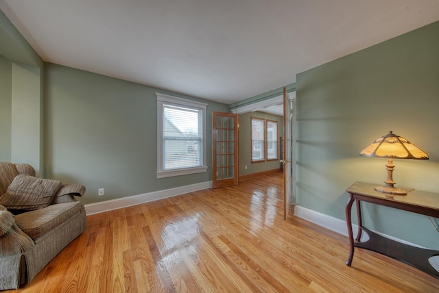 living area featuring baseboards and wood finished floors