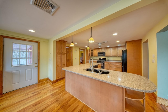 kitchen featuring light wood finished floors, visible vents, black appliances, a sink, and recessed lighting