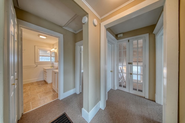 bathroom with ornamental molding, french doors, vanity, and baseboards