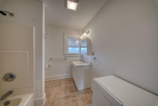 bathroom featuring shower / bathing tub combination, tile patterned flooring, vanity, and baseboards