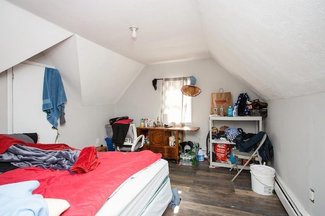 bedroom featuring a baseboard heating unit, lofted ceiling, and wood finished floors