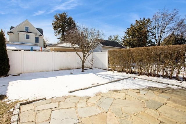 snow covered patio with fence