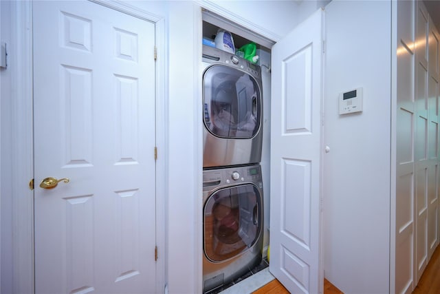 laundry area featuring stacked washer / dryer and laundry area