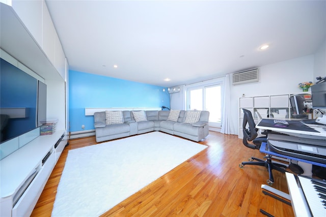 living room with a baseboard heating unit, light wood-style flooring, recessed lighting, and a wall mounted air conditioner